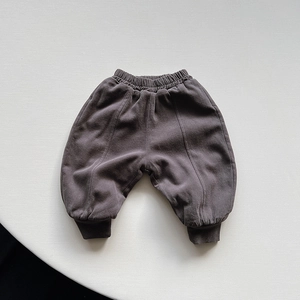 Close-up of winter children's thick warm fleece pants in dark grey-brown with ribbed cuffs