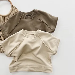 Detail of raw-edge knit vests in earth tones and beige with natural rustic texture