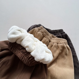 Close-up of winter velvet corduroy trousers for children with warm fleece lining detail