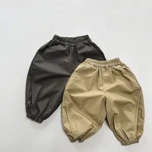 Detailed flat lay of soft cotton kids harem pants in dark grey and khaki beige colors