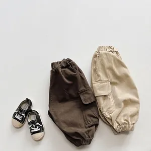 Retro cargo pants for kids in khaki and brown colors with elastic cuffs and large pockets