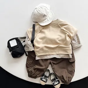 Kids streetwear set with beige vest, striped shirt, and brown cargo pants in flat lay style