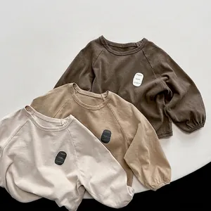 Three-piece set of cotton long-sleeve kids sweatshirts in brown, khaki, and cream colors