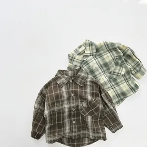 Detail view of retro plaid cotton shirts for kids in brown and yellow green grid patterns