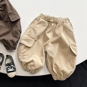 Detail of kids cargo pants showing durable cotton fabric and large side utility pockets