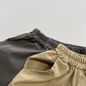 Close-up of elastic waistband and side pockets on cotton kids casual shorts