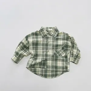 Detail of children's vintage plaid shirt with classic collar and front button pocket