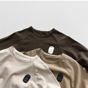 Three long sleeve cotton t-shirts for kids in earth tones with vintage chest patches