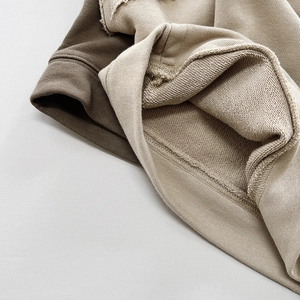 Close-up of thick ribbed cuffs and soft French terry texture in brown and beige colors