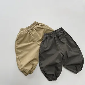 Close-up of khaki and dark grey cotton joggers with elastic waist and ribbed cuffs