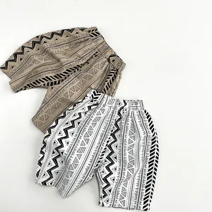 Detailed flat lay of geometric pattern cotton shorts for kids in khaki and beige tones