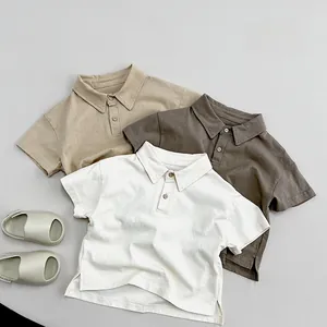 Detailed flat lay of children's cotton polo shirts in earth tones and soft summer fabric
