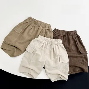 Detail of kids linen cargo shorts in khaki, off-white, and dark brown colors
