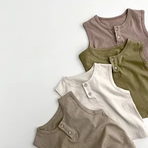 Flat lay of four cotton Henley baby vests in earth tones with wooden buttons