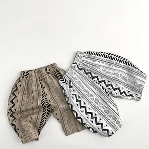 Detail of bohemian geometric prints on kids soft cotton wide-leg pants with elastic waist