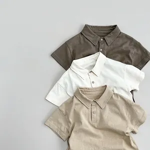 Detail of three cotton polo shirts in brown, cream and khaki with premium texture
