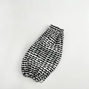 Flat lay of linen kids casual pants featuring black and white wavy zigzag pattern