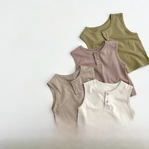 Detail view of cotton knit baby tank tops featuring Henley neck design in earth tones