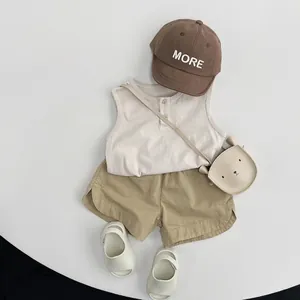 Minimalist summer cotton set for kids featuring beige sleeveless top and khaki shorts