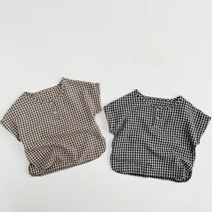 Flat lay of brown and black small checkered cotton kids' shirts with dual front buttons
