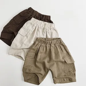 Detail of cargo pockets and cotton linen texture on kids casual shorts in three colors