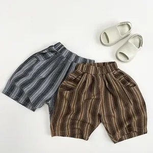 Detailed flat lay of striped cotton shorts for kids in grey and brown color options