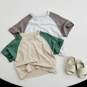 Close-up of raglan sleeve kids' cotton t-shirts with slub texture and breathable fabric