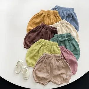 Flat lay of multiple colors cotton muslin bloomer shorts for babies with soft texture