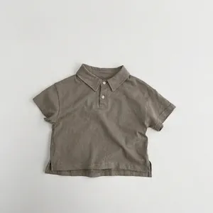 Close-up of kids cotton polo shirt showing fabric texture, buttons and side slit detail