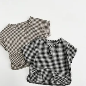 Flat lay of brown and black plaid cotton shirts for kids featuring round neck and buttons