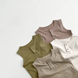 Flat lay detail of kids' cotton knit vests showing Henley collars and various earth tones
