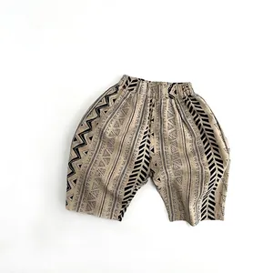 Detail view of children's cotton pants featuring geometric prints and elastic waistband
