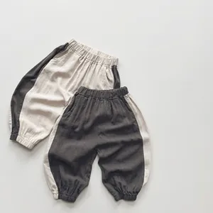Detail view of cotton-linen toddler joggers featuring elastic waist and contrast side stripes