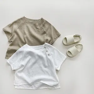 Detail view of cotton linen baby sleeveless vest with side buttons in white and khaki