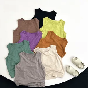 Stack of multi-color cotton tank tops for kids featuring breathable slub fabric texture