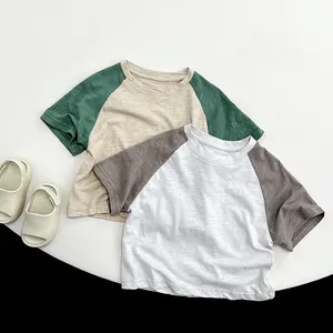 Close-up of slub cotton texture and raglan sleeve seams on kids casual t-shirts