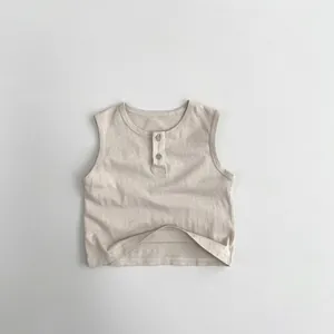 Detail of minimalist beige cotton kids tank top with Henley collar and wooden buttons