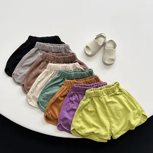 Detailed flat lay showing eight colors of breathable cotton shorts for children
