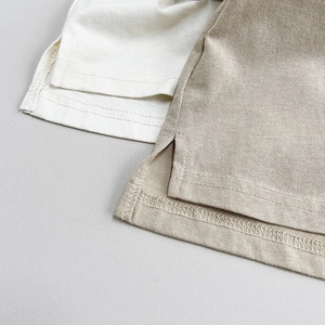 Detail of the side slits and double-stitched hem on cotton knitted polo shirts for kids
