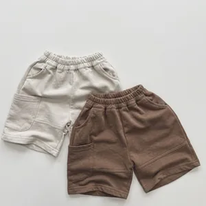 Detailed view of kids cotton shorts set with elastic waistband and side pockets