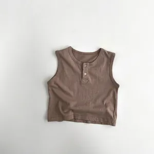 Detail view of cotton knit toddler vest with brown color and wood-style buttons