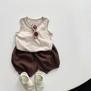 Detail view of baby cotton linen bloomers and beige vest set for summer wear