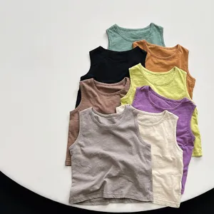 Flat lay of colorful children's slub cotton tank tops in eight assorted earthy tones