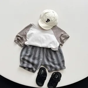 Kids minimalist raglan sleeve cotton T-shirt set with striped shorts and cap in neutral tones