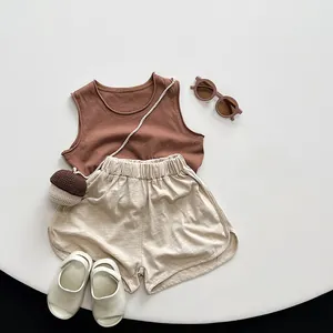 Flat lay of breathable cotton summer set with sleeveless vest and elastic shorts for toddlers