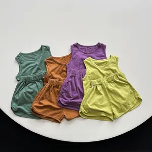 Flat lay of breathable cotton summer sets for toddlers in four vibrant colors