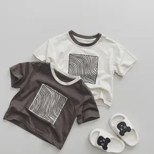 Flat lay of cotton t-shirts with wave pattern and bear slippers for children summer wear