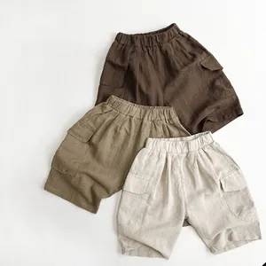 Flat lay of linen-cotton kids cargo shorts in brown, camel and beige earthy tones
