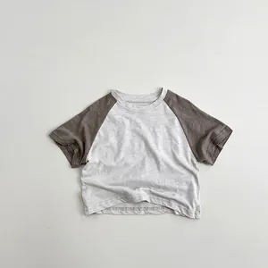 Detail of raglan sleeves and contrast color stitching on kids cotton t-shirt