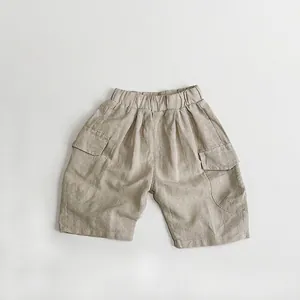 Detail view of khaki cotton linen cargo shorts with elastic waist and large flap pockets